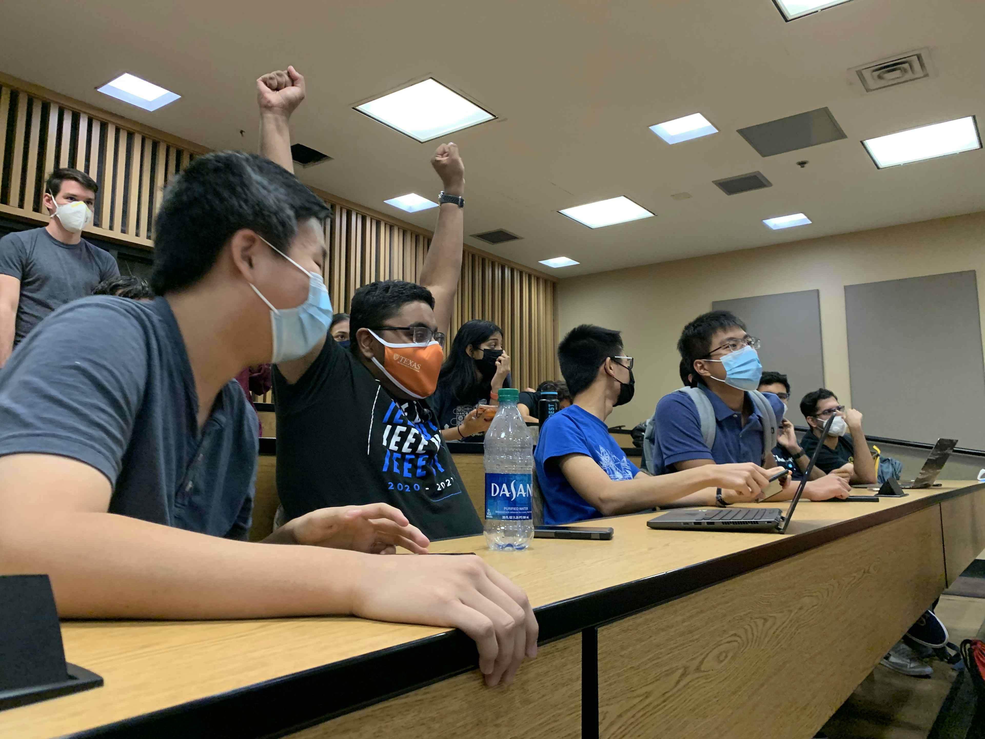 Members cheer and excited in lecture hall