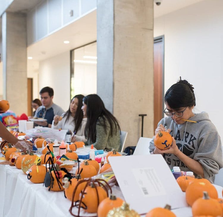 IEEE members paint mini pumpkins for halloween social
