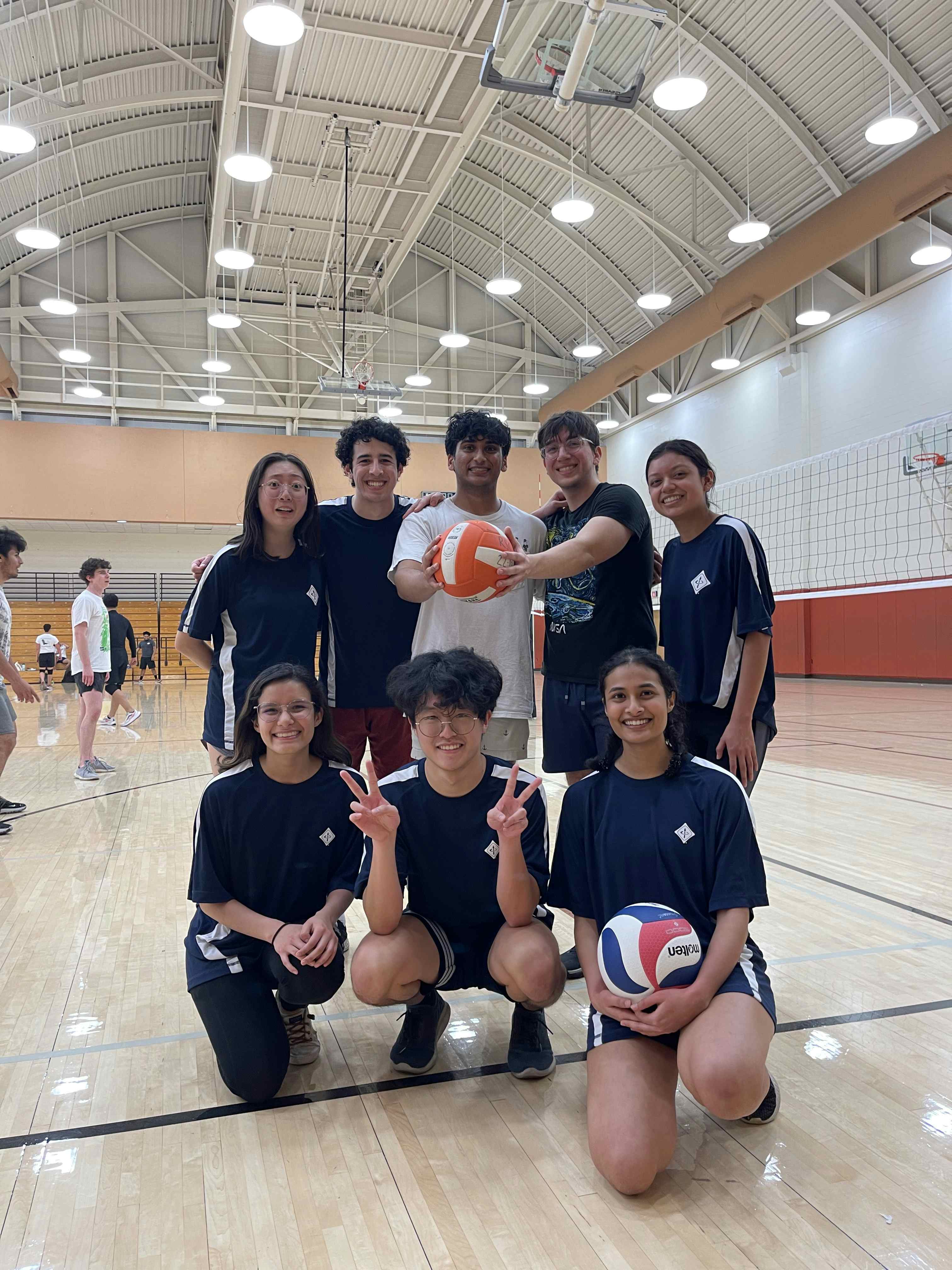 Group photo of volleyball intramural team on volleyball court